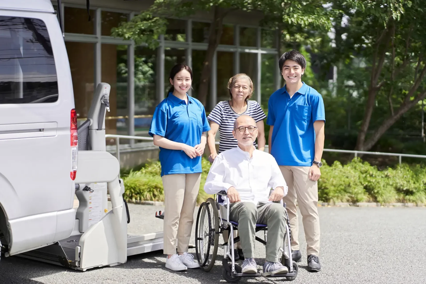 Older adult using a wheelchair with caregivers