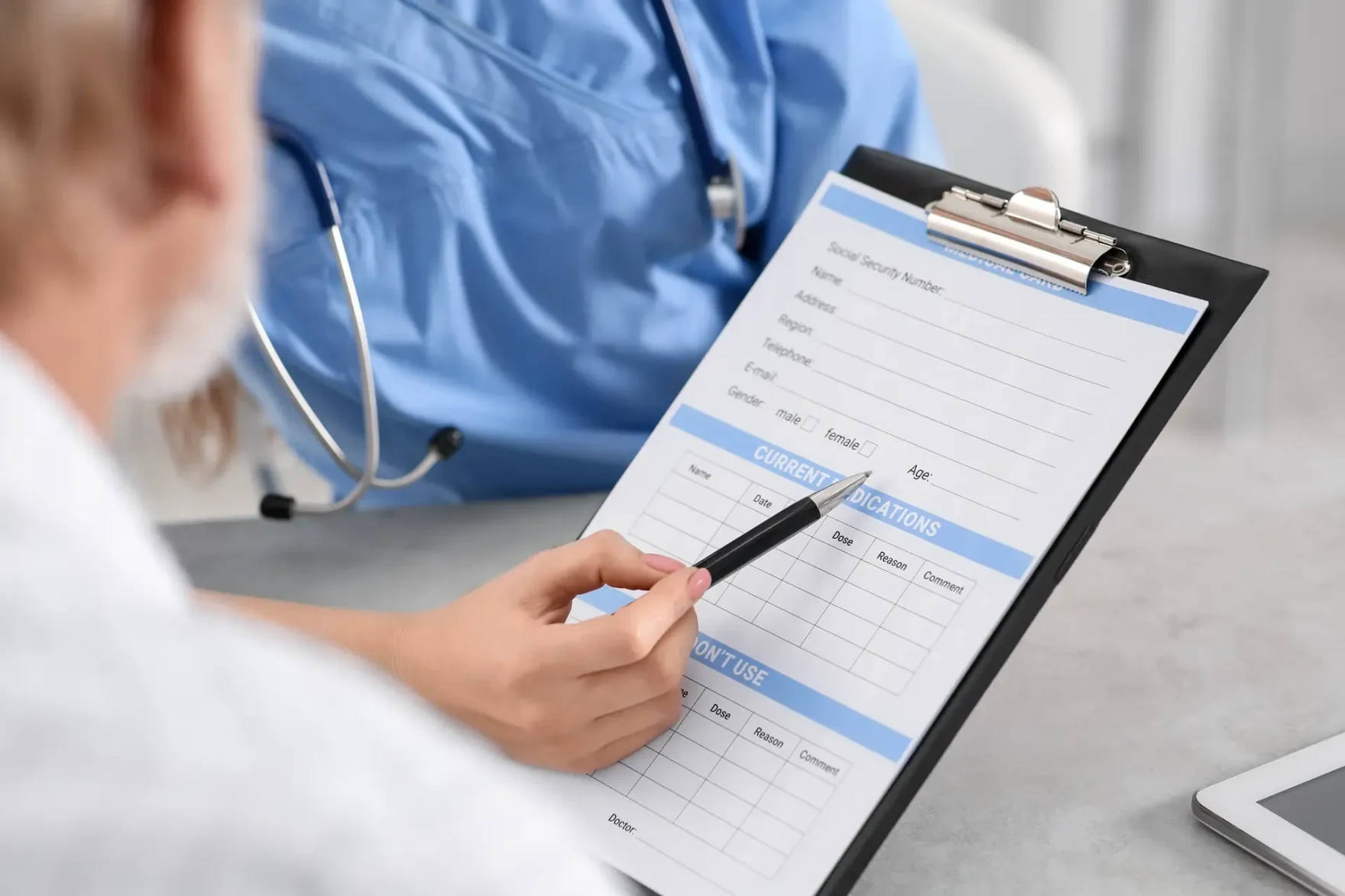 Doctor showing a healthcare card to a patient