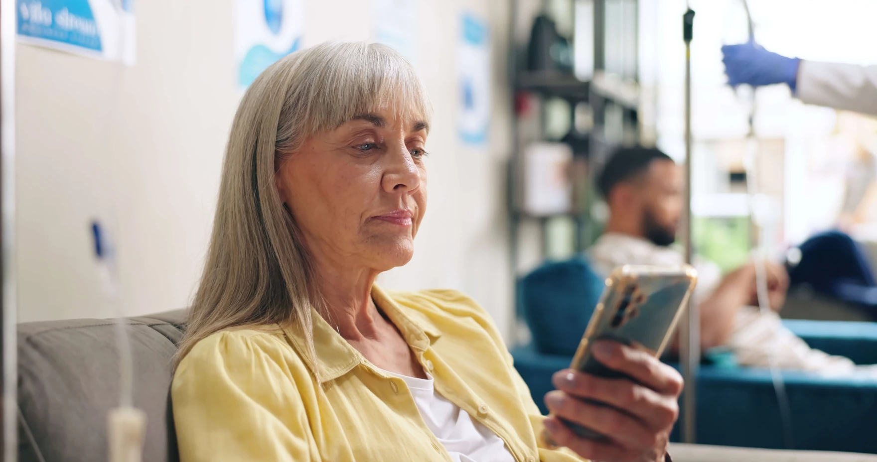 Older patient speaking by phone during hospital care