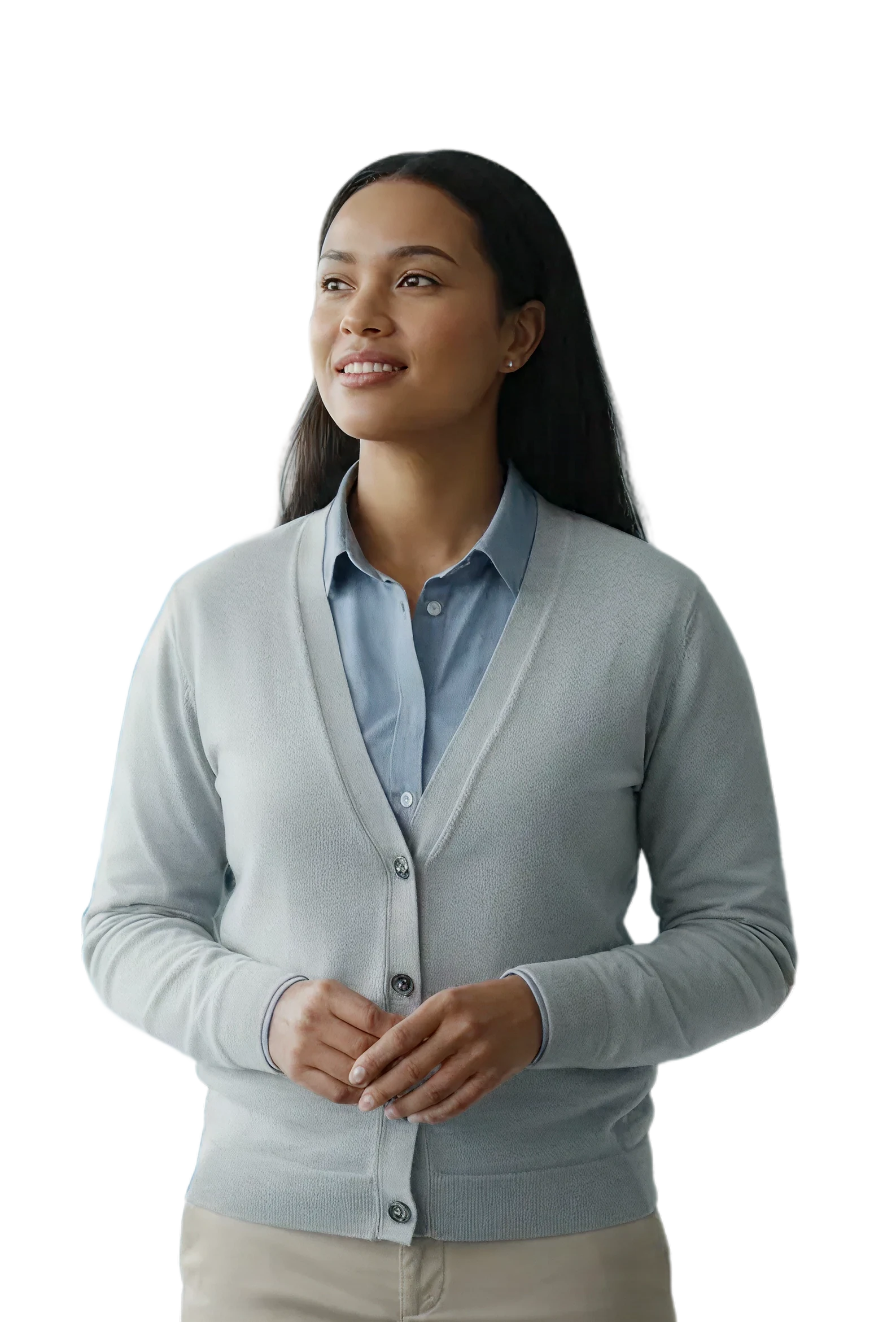 A healthcare worker in a cardigan standing in front of a softly blurred clinic waiting room